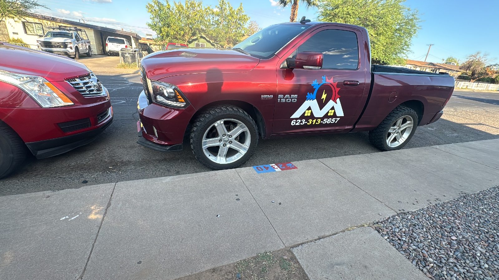 The Mendoza A/C Solutions pickup parked on a Phoenix street, the company logo and phone number signwritten on the door.